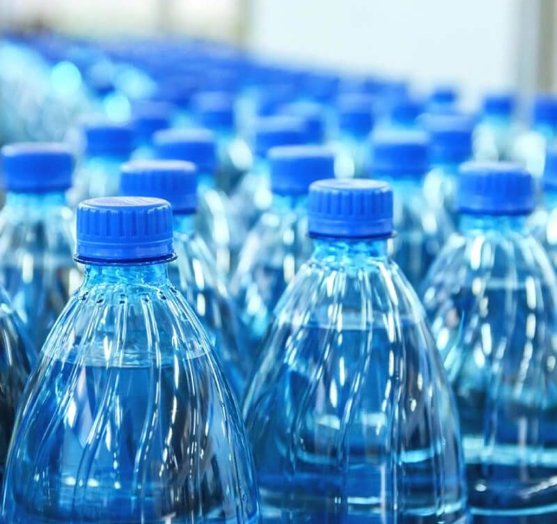 A close up of many water bottles in a row