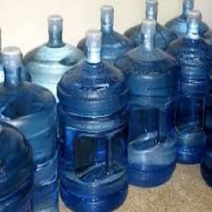 A group of water bottles sitting on top of a counter.